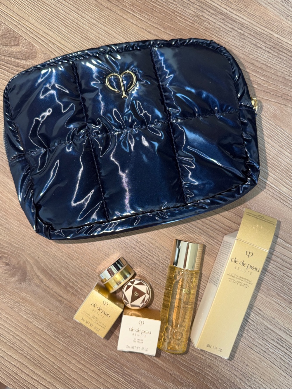 Cle de Peau skincare and Navy Quilted Cosmetic Pouch